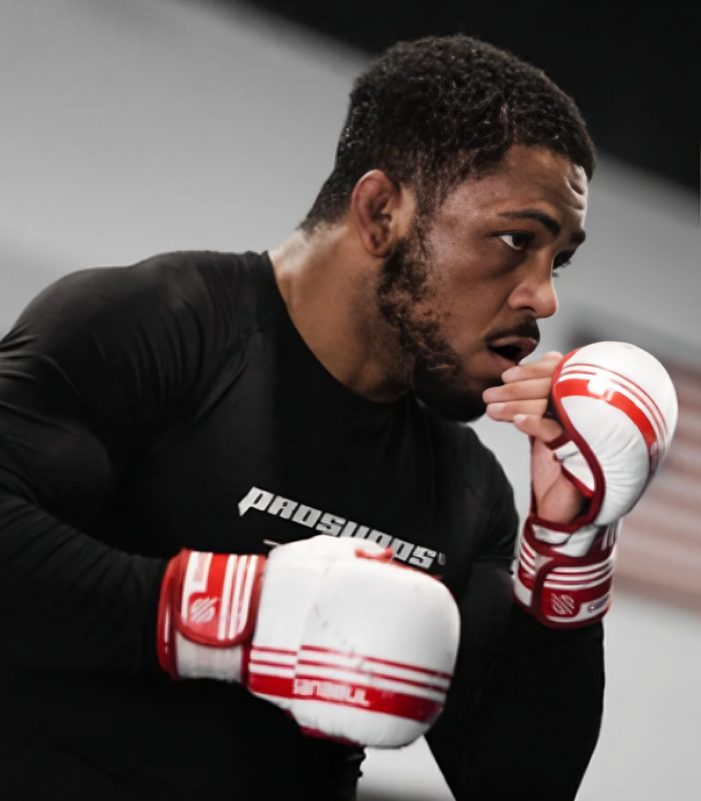 Boxer in black shirt using boxing gloves