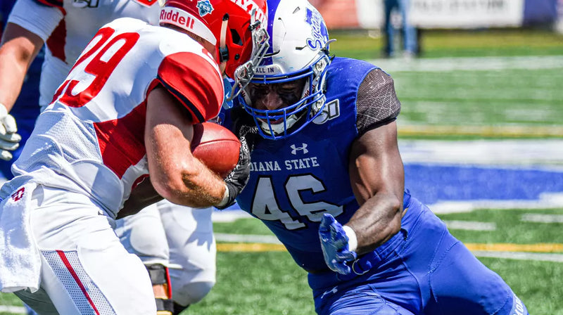 Two football players in action on a field