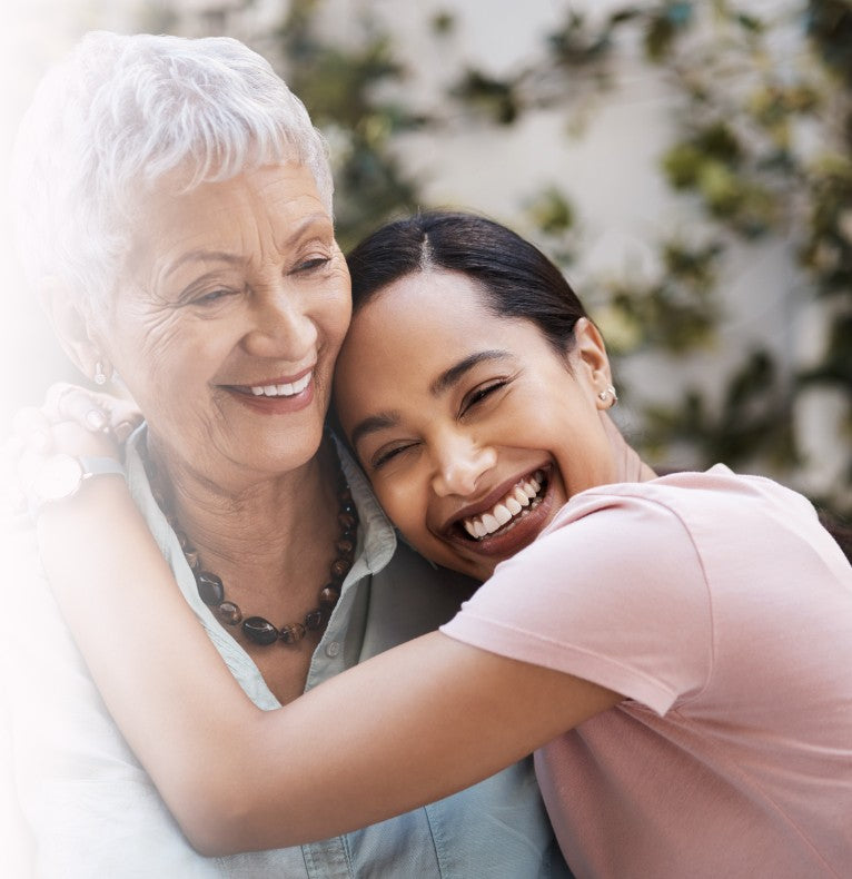 Smiling mother and daughter hugging